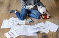 Woman managing the debt sitting beside pet dog Royalty Free Stock Photo