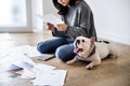 Woman managing the debt sitting with pet dog Royalty Free Stock Photo