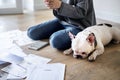 Woman managing the debt and using phone near pet dog Royalty Free Stock Photo