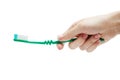 Woman manicured hand holding a toothbrush on white background