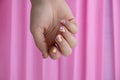 Woman manicured hands, stylish summer colorful nails on pink background. Closeup of manicured nails of female hand