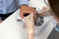 Woman manicurist master is cutting culicle on client`s man nails, closeup view. Royalty Free Stock Photo