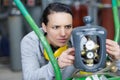 woman manual worker turning cut-off valve at plant Royalty Free Stock Photo