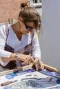 Woman manufacturer working with stain glass