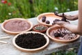 Woman is manufacturing seed balls or seed bombs on a wooden table