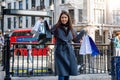 A woman with many shopping bags in her hand in the center of London, United Kingddom