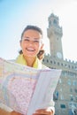 Woman with map in front of palazzo vecchio, Italy Royalty Free Stock Photo