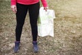 Woman with map in her hands is standing on ground. girl in hike Royalty Free Stock Photo