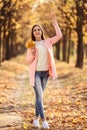 Woman with maple leafs in park