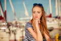 Woman in marina against yachts in port