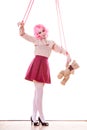 Woman marionette on string with teddy bear Royalty Free Stock Photo