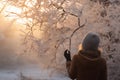 Woman marveling at intricate frost patterns on winter morning. Generative AI