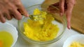 Woman mashing boiled potatoes with fork in bowl cooking draniki, pancakes.