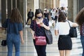 woman with mask checking the app Stop Covid on the smartphone