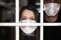 A woman in a mask , looking intently at the camera. Quarantine and isolation of patients with covid coronavirus 2019