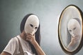 Woman with mask looks in the mirror to see if she knows herself Royalty Free Stock Photo