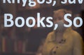 Woman with mask working in a book store or library