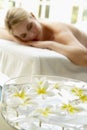 Woman On Massage Table With Flowers In Foreground Royalty Free Stock Photo