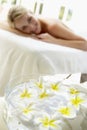 Woman On Massage Table With Flowers In Foreground Royalty Free Stock Photo