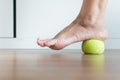 Women massage with tennis ball to her foot in bedroom,Feet soles massage for plantar fasciitis
