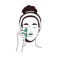 Woman massaging face with guasha scraper. Young girl applying gua sha jade tool. Female with beauty facial stone