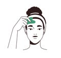 Woman massaging face skin with gua sha jade scraper. Young girl using beauty facial guasha massager for forehead