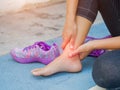 Woman massaging her painful ankle. Royalty Free Stock Photo