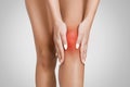 Woman massaging her sore injured knee, closeup