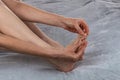 Woman massaging her toes. Revitalizing foot massage. Women& x27;s feet health care. Close-up of female hands doing Royalty Free Stock Photo