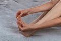 Woman massaging her toes. Revitalizing foot massage. Women& x27;s feet health care. Close-up of female hands doing Royalty Free Stock Photo