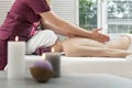 Woman masseur doing back massage to female client in spa center. Girl enjoying relaxing massage in beauty salon Royalty Free Stock Photo