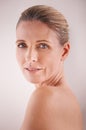 Woman, mature and studio with skincare, portrait and cosmetic with treatment. Model, beauty and luxury with body