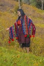 Woman of Mayan identity with typical costume walking among wheat in the forest and natural field in cajola