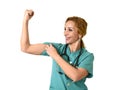 Woman md emergency doctor or nurse posing smiling cheerful with stethoscope showing biceps Royalty Free Stock Photo