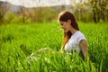 woman on the meadow relaxing and using a laptop Royalty Free Stock Photo