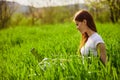 woman on the meadow relaxing and using a laptop Royalty Free Stock Photo