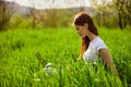 woman on the meadow relaxing and using a laptop Royalty Free Stock Photo