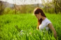 woman on the meadow relaxing and using a laptop Royalty Free Stock Photo