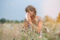 Woman in meadow snorts in handkerchief Royalty Free Stock Photo