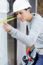 woman with measure level tool on construction site Royalty Free Stock Photo