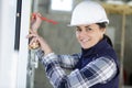 woman with measure level tool on construction site Royalty Free Stock Photo