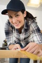 woman measure wood plank before saw Royalty Free Stock Photo