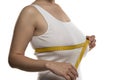 A woman measures with a measuring tape her large breasts Royalty Free Stock Photo