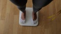 Woman Measuring Body Weight On Weighing Scale At Home. Royalty Free Stock Photo