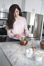 Woman measuring flour for cake in the kitchen Royalty Free Stock Photo