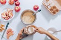 Woman measuring flour for dough to prepare apple pie