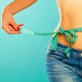 Woman measuring her waist over white background. Wellness concept Royalty Free Stock Photo