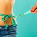 Woman measuring her waist over white background. Wellness concept Royalty Free Stock Photo