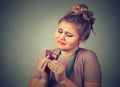 Woman with measuring tape tired of diet restrictions craving sweets chocolate Royalty Free Stock Photo