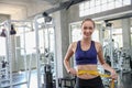 Woman measuring waist in gym. Slim woman measuring her thin waist with a tape measure. smiling people with measure tape in the sp